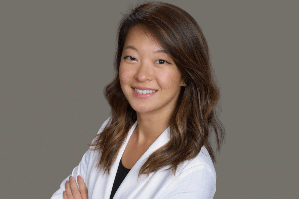 Portrait of Dr. Tarim Song smiling in a white coat for board-certified orthodontist profile, Beaverton Orthodontics, Beaverton, OR 97007