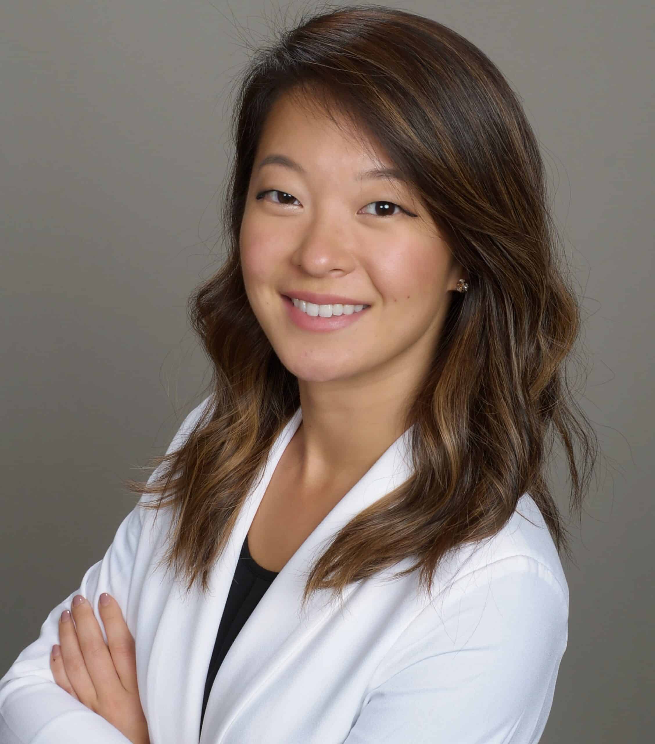 Portrait of Dr. Tarim Song smiling in a white coat beside education and professional training information, Beaverton Orthodontics, Beaverton, OR 97007