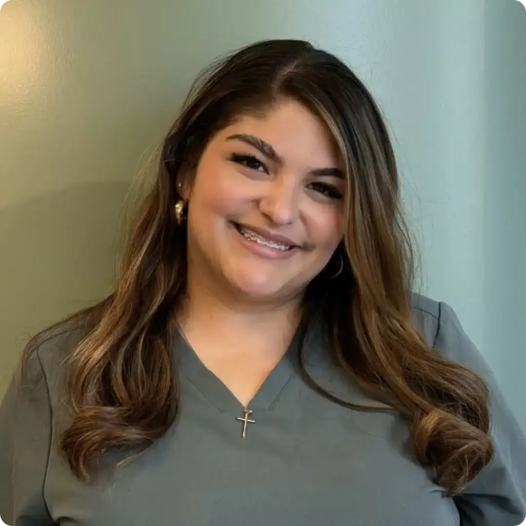 Emily, Orthodontic Assistant, smiling in scrubs in a professional portrait at Beaverton Orthodontics in Beaverton, OR