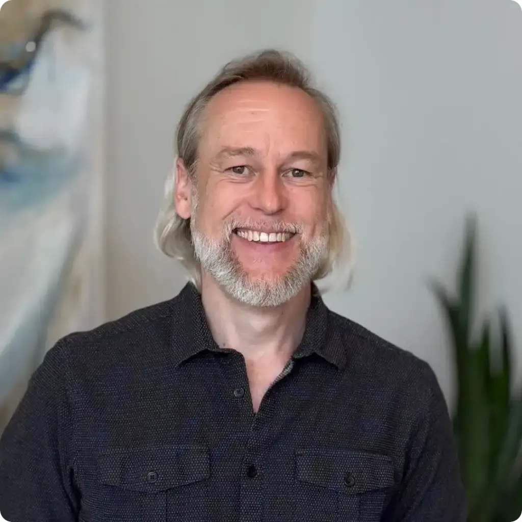 Mike, Lab Technician, smiling with a gray beard in a professional portrait at Beaverton Orthodontics in Beaverton, OR