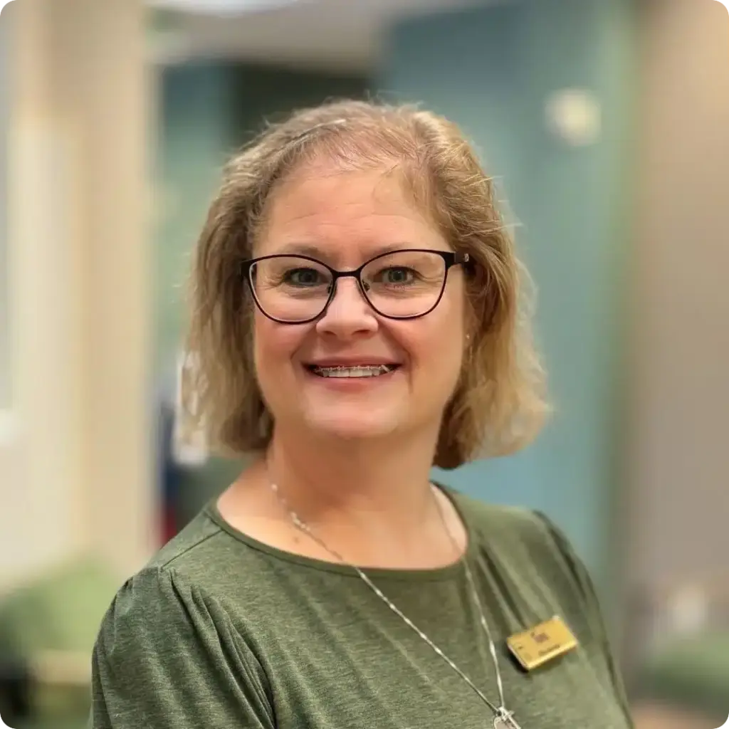 Toni, Financial Coordinator, smiling in glasses in a professional portrait at Beaverton Orthodontics in Beaverton, OR